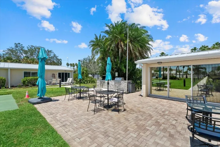 Outdoor grilling area with seating.