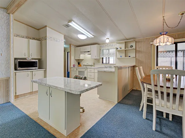 KITCHEN WITH ADJOINING DINING AREA.