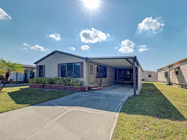 FRONT ENTRY AND LARGE COVERED CARPORT