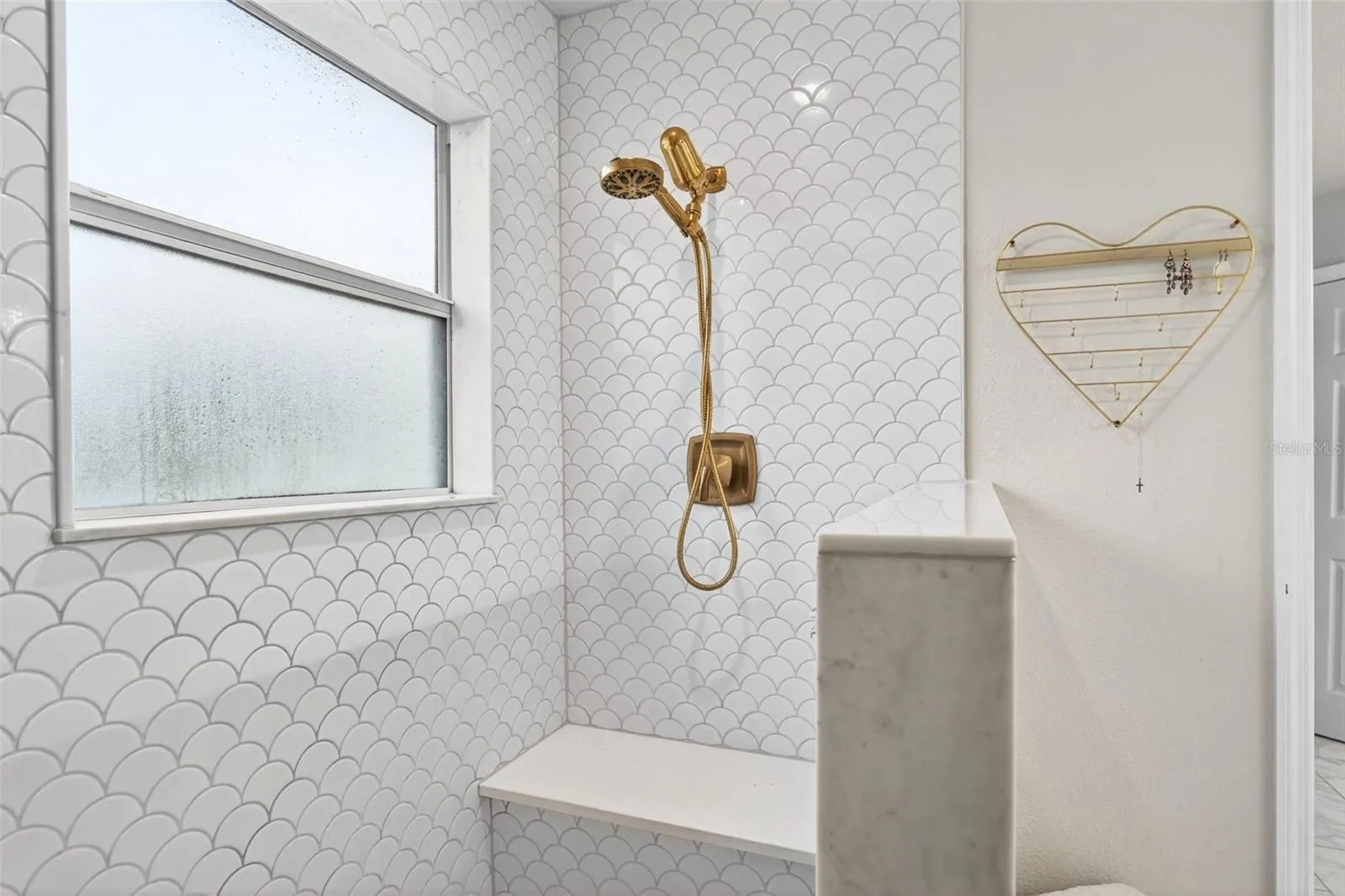 Beautiful wall tile, shower faucets with easy hand held capability but a spacious sized bench