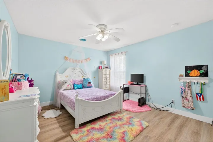 Cute spacious bedroom with view of the backyard and greenbelt area.