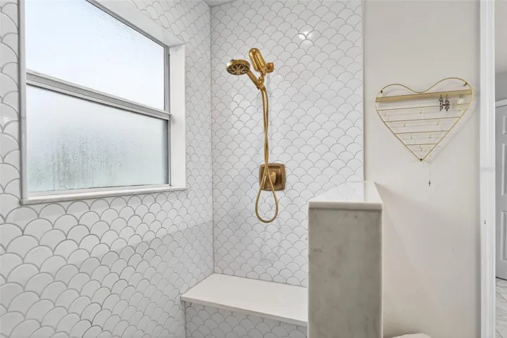 Beautiful wall tile, shower faucets with easy hand held capability but a spacious sized bench