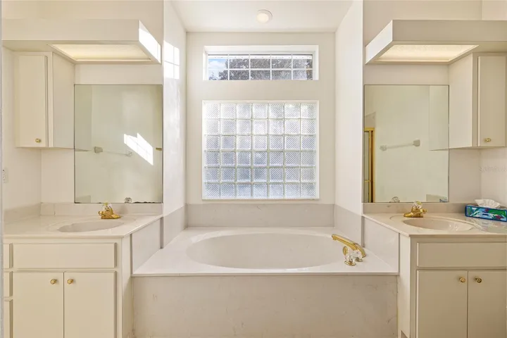 Master bath has soaking tub and double vanities