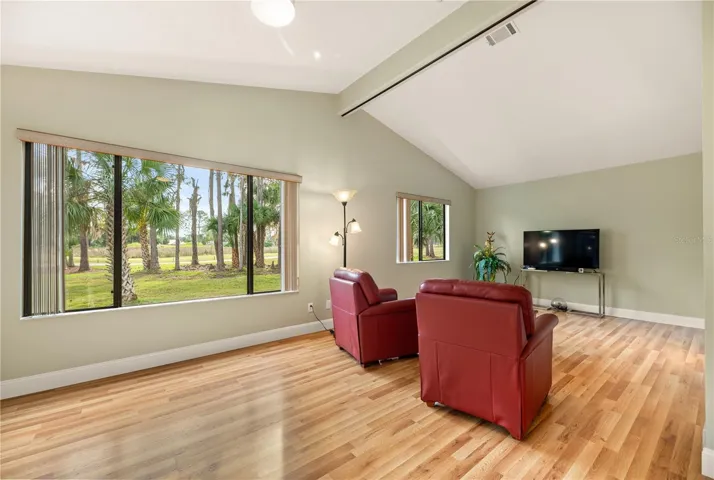 In-law suite living quarters/room can be split into two to provide a family room with separate bedroom with a room divider that is stored in wall. Picture shows room divider stored