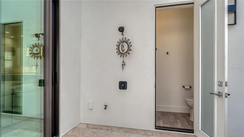 Out door shower and half bath off pool deck.