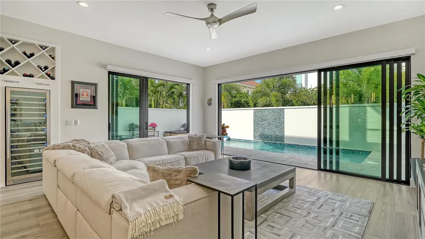 Great room with wine cooler and custom built wine rack.
