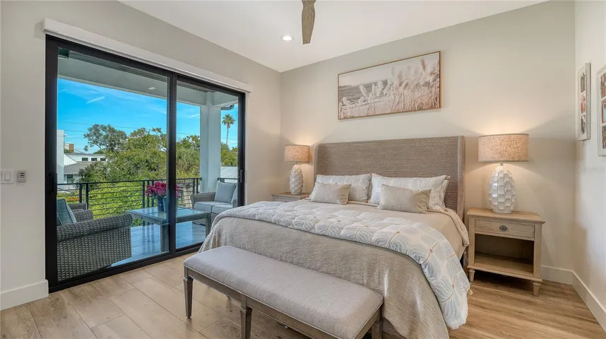 Bedroom 3 features ceiling fan, dual closets with built in shelving and drawers and sliders to the back balcony overlooking the pool.