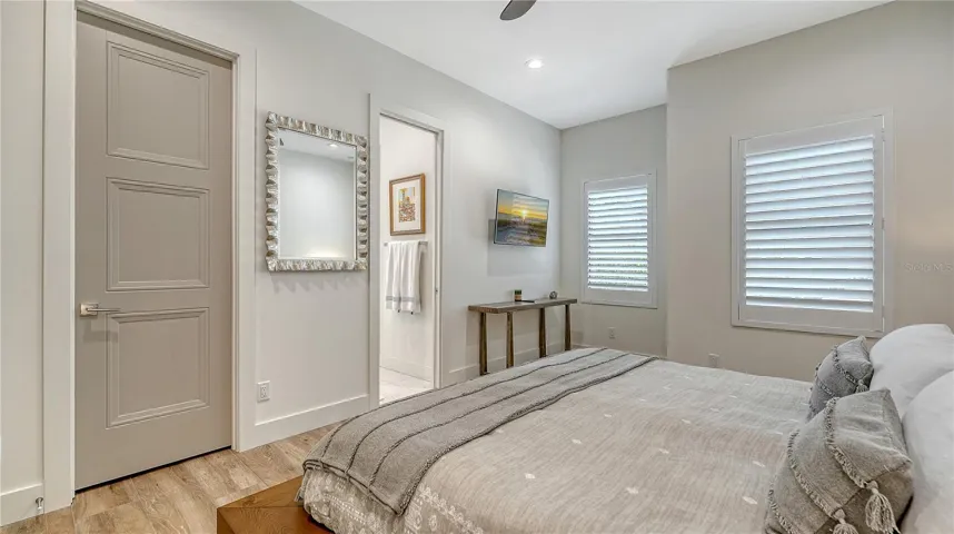 Bedroom two features ceiling fan, walk-in closet, plantation shutters and Jack and Jill bathroom.
