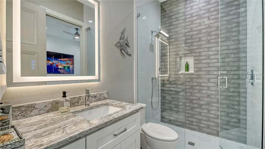 First floor bathroom with walk-in shower,  shower head and separate hand held sprayer.