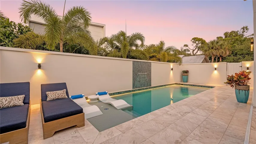 Twilight view of pool. Virtually staged