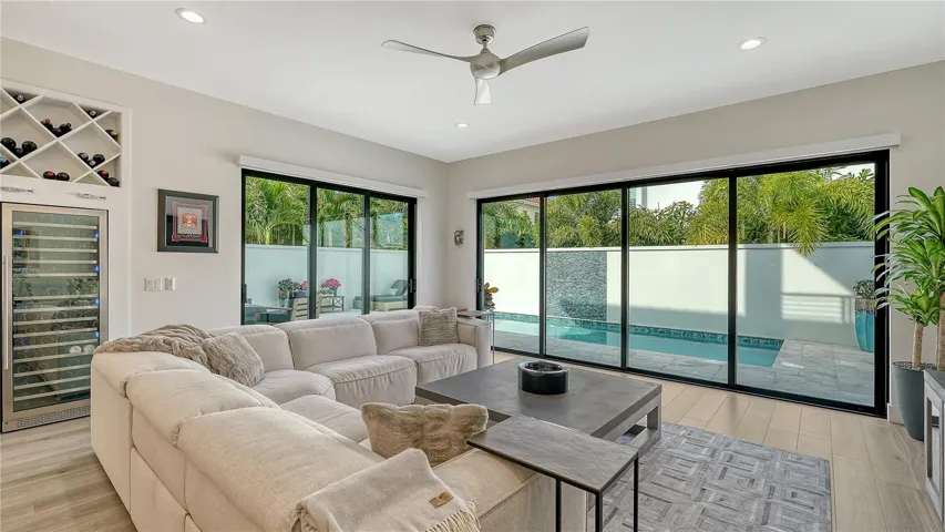 Great room with sliders to pool and outdoor kitchen.