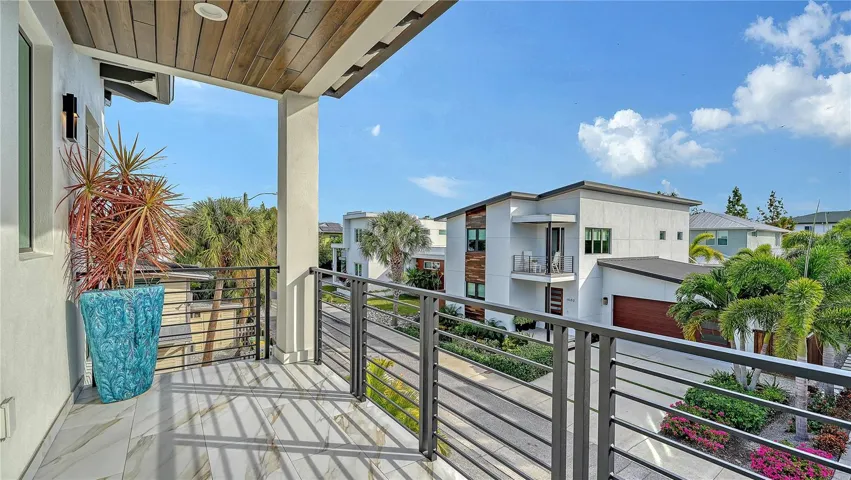 Upstairs front Balcony featuring teak ceiling with view of neighorhood. Great for watching the morning sunrise with your coffee.