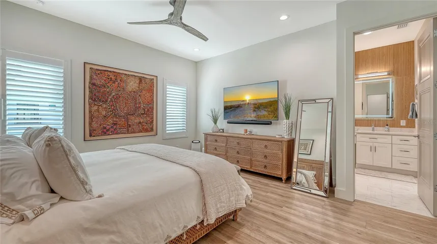 Primary bedroom with ensuite bath, ceiling fan and large walk-in closet.