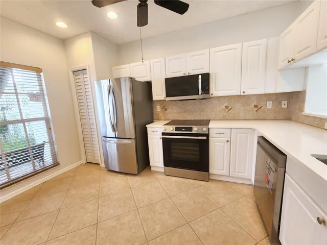 Eat-in kitchen with a breakfast bar and large windows for natural light.