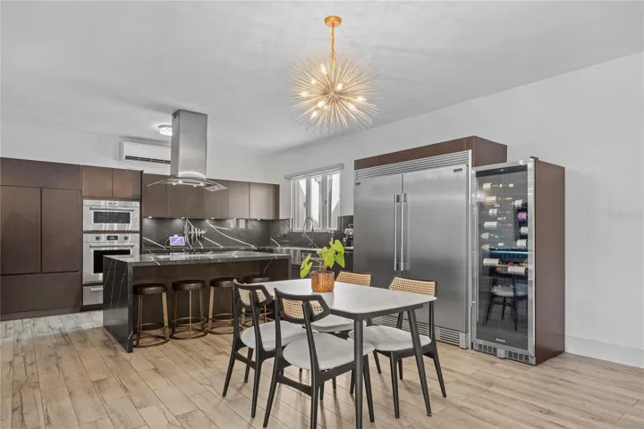 •New kitchen with Wolf microwave, oven, warming drawer, and Induction cook top.  New commercial size freezer and refrigerator.