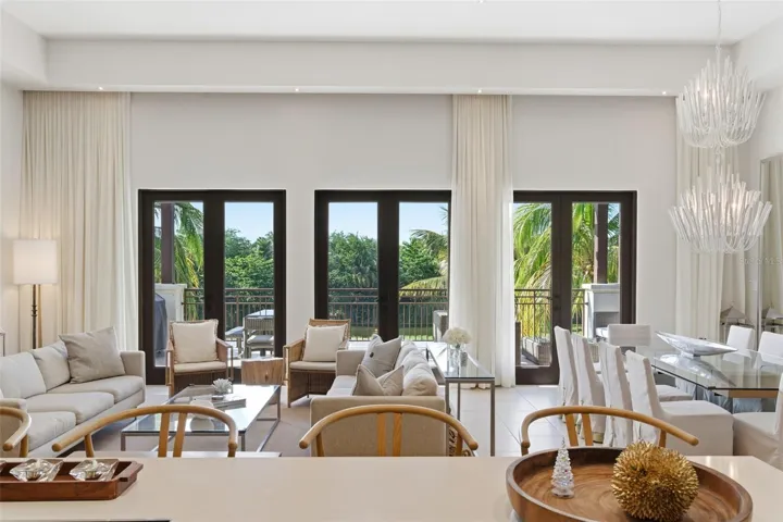 Sunlit living spaces framed by floor-to-ceiling doors, inviting the outdoors in and offering views of Bahia Beach's tropical landscape.