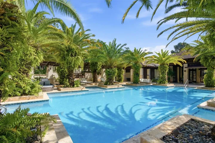 Relax by the resort-style pool framed by vibrant green scenery and tropical calm.