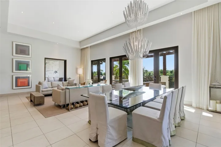 An elegant dining space enhanced by statement lighting and panoramic views, a perfect setting for memorable gatherings.