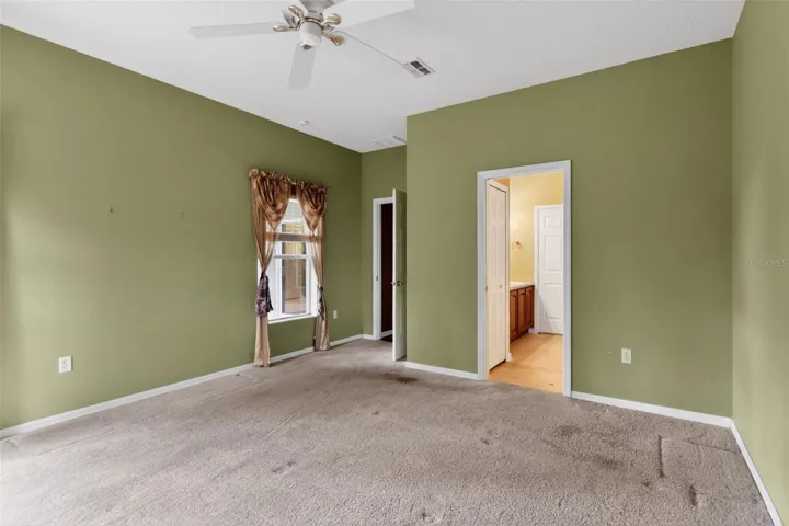 Large, primary bedroom with ceiling fan