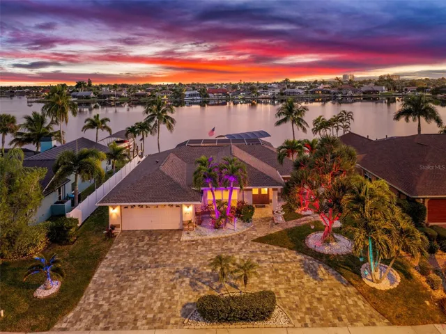 Welcome to the stunning evening setting at 626 Cape Coral Pkwy West. Twilight view of the lake