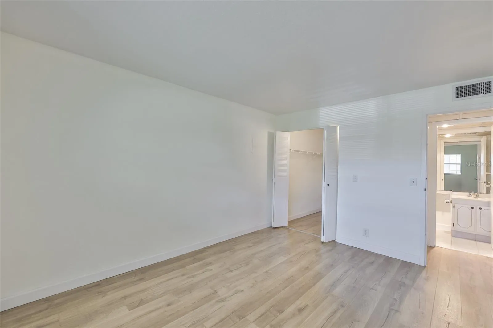 Primary bedroom, walk-in closet left, primary bath right and hallway