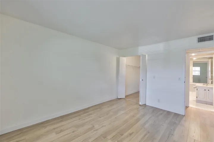 Primary bedroom, walk-in closet left, primary bath right and hallway