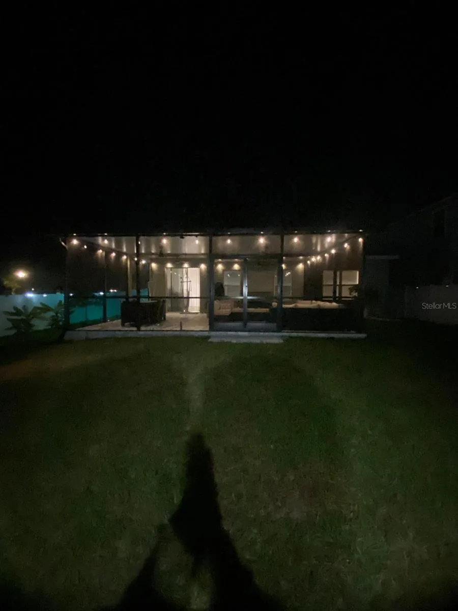 View of the back porch at night with all the ambient lights