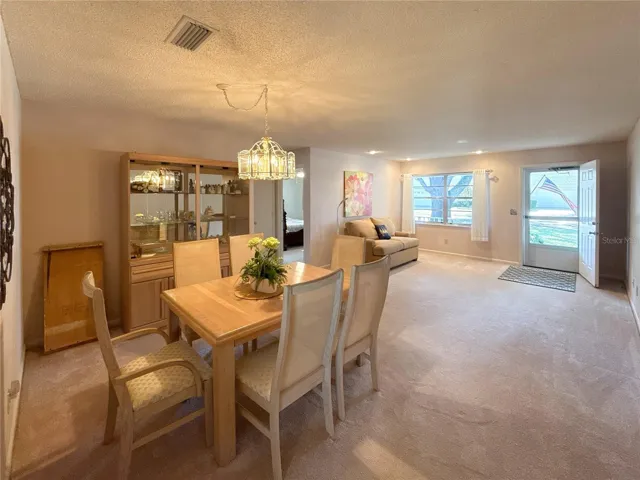 View from the kitchen looking into the open dining and living room combo, showcasing the home’s inviting layout.