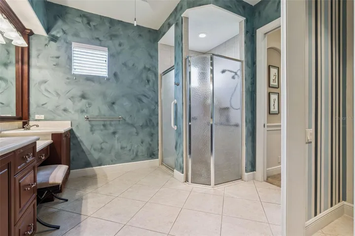 Primary Bathroom w/ glass enclosed walk-in shower & grab bars