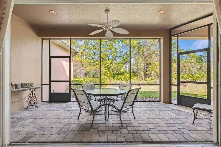 21' x 9' Screen enclosed covered patio w/ ceiling fan, recessed lights & a conservation area view