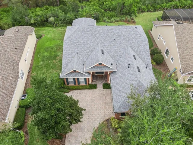 Aerial view from in front of the home w/ conservation area behind