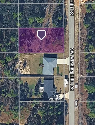 Aerial view of lot showing houses nearby.
