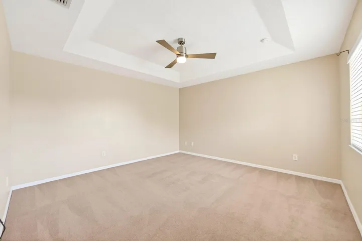 The spacious Primary Suite serves as a relaxing retreat with an ELEGANT TRAY CEILING, walk-in closet, and private en suite bath.