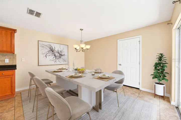 The ADJACENT DINING AREA offers sliding glass doors leading to the patio, creating an effortless INDOOR-OUTDOOR CONNECTION. Virtually Staged