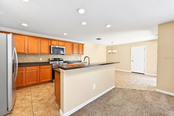 The Kitchen island is designed to accommodate counter-height stools, adding both function and casual seating.