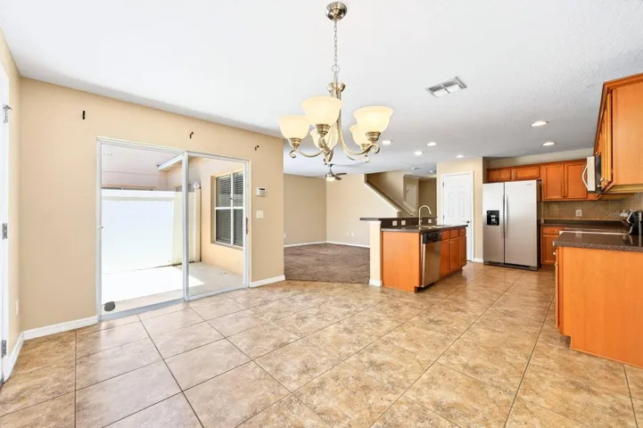 The ADJACENT DINING AREA offers sliding glass doors leading to the patio, creating an effortless INDOOR-OUTDOOR CONNECTION.