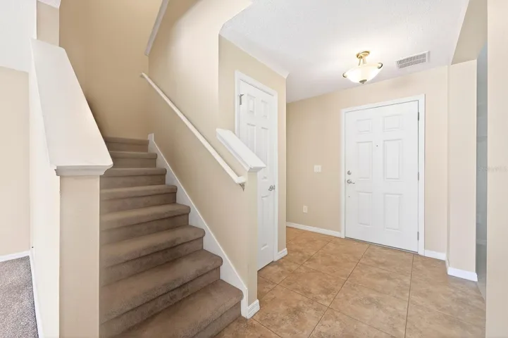Step inside to find a welcoming FORMAL LIVING ROOM before the home opens into a spacious and LIGHT-FILLED GATHERING AREA where the Family Room, Dining space, and Kitchen connect seamlessly.