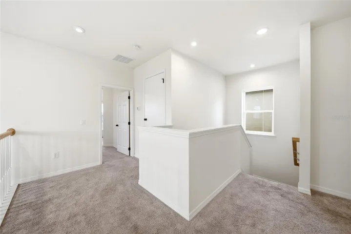 Upstairs walkway from Stairway to Primary Bedroom