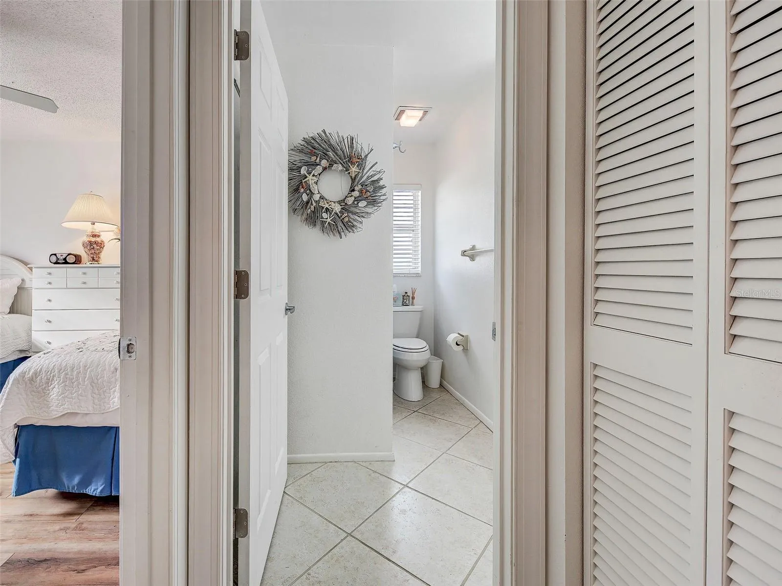 guest bath with shower/bathtub. Guest bedroom to the left