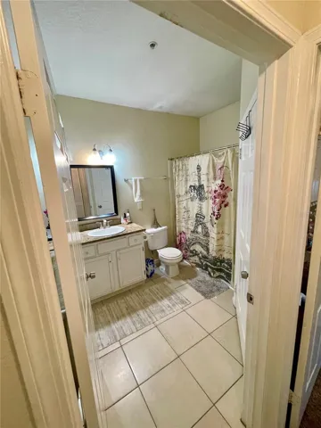 Primary bathroom with separate entrances. Hallway and primary bedroom access.