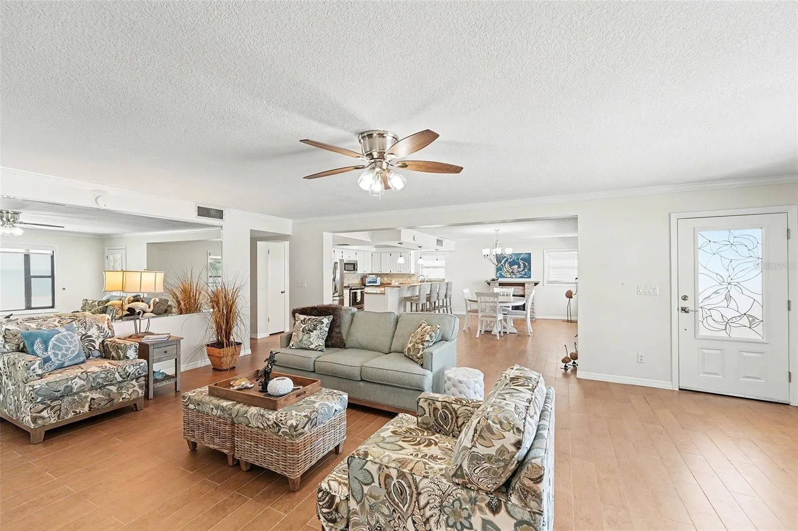 Enjoy the second level with its open design concept with a combined living room, kitchen, large dining room, and fireplace.  Large picture windows are in each room with remote shades and frame the beautiful and unique sunsets each evening.