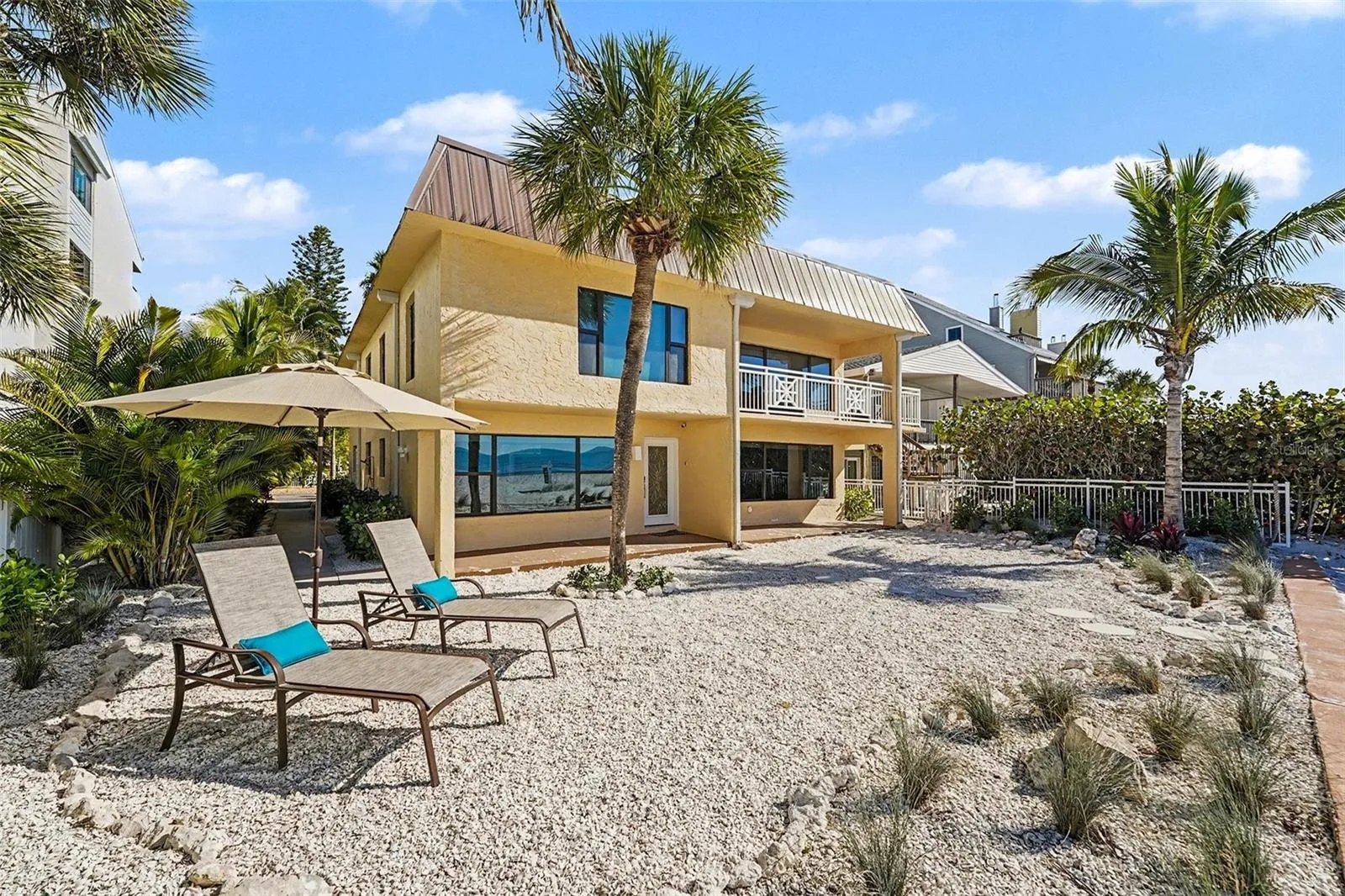 The property is configured as two full, condo-style living spaces with a total of five bedrooms and four baths and separate entrances.