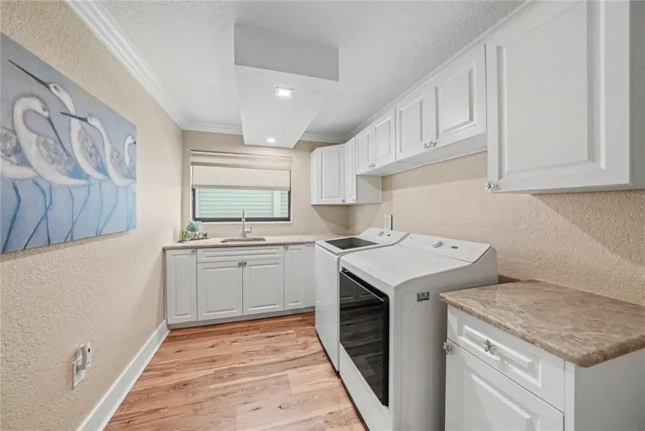 First level oversized laundry room offers more storage, new cabinets, & new washer and dryer.