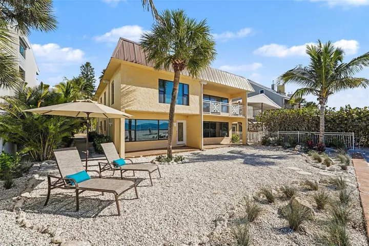 The property is configured as two full, condo-style living spaces with a total of five bedrooms and four baths and separate entrances.