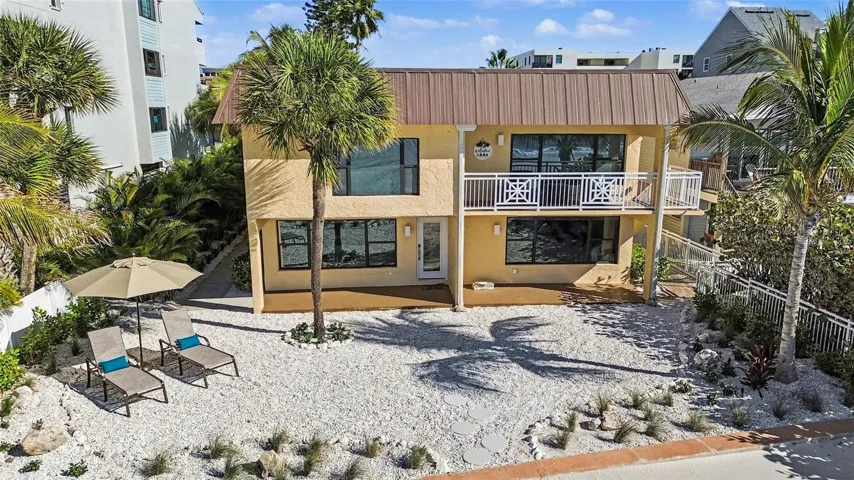 New tropical landscaping is featured on both the front and beachside, along with enhanced landscape lighting that highlights the elegant palm trees and walkways, and further elevates the home’s coastal appeal.