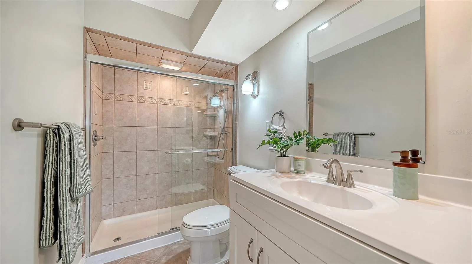 Guest Bathroom, also with granite countertop and glassed walk-in shower.