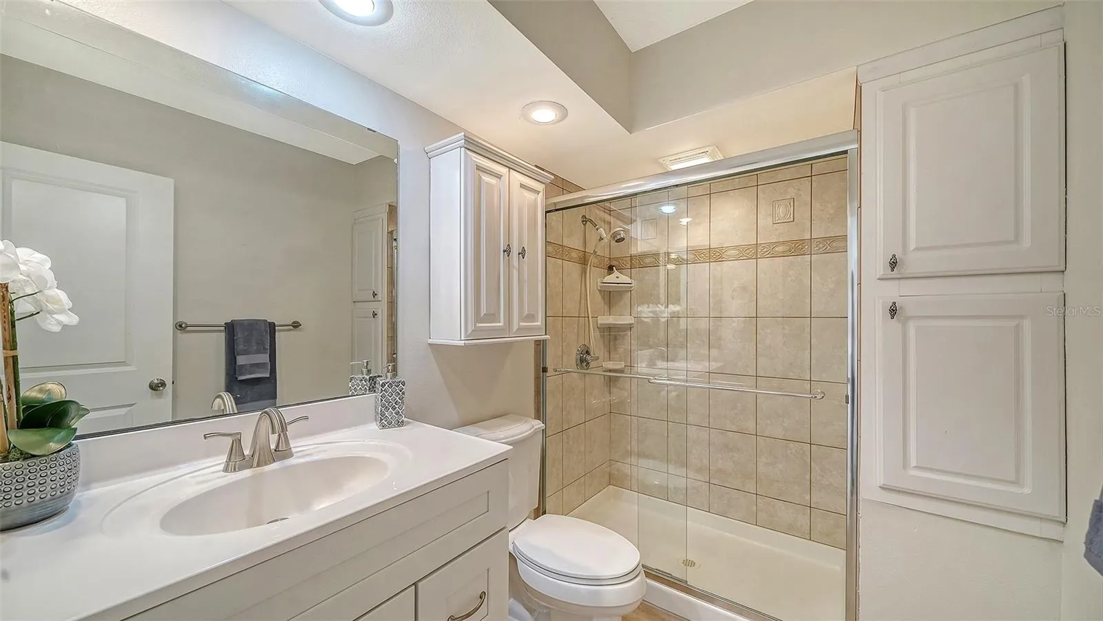 Primary Bathroom with granite counters and walk-in shower.