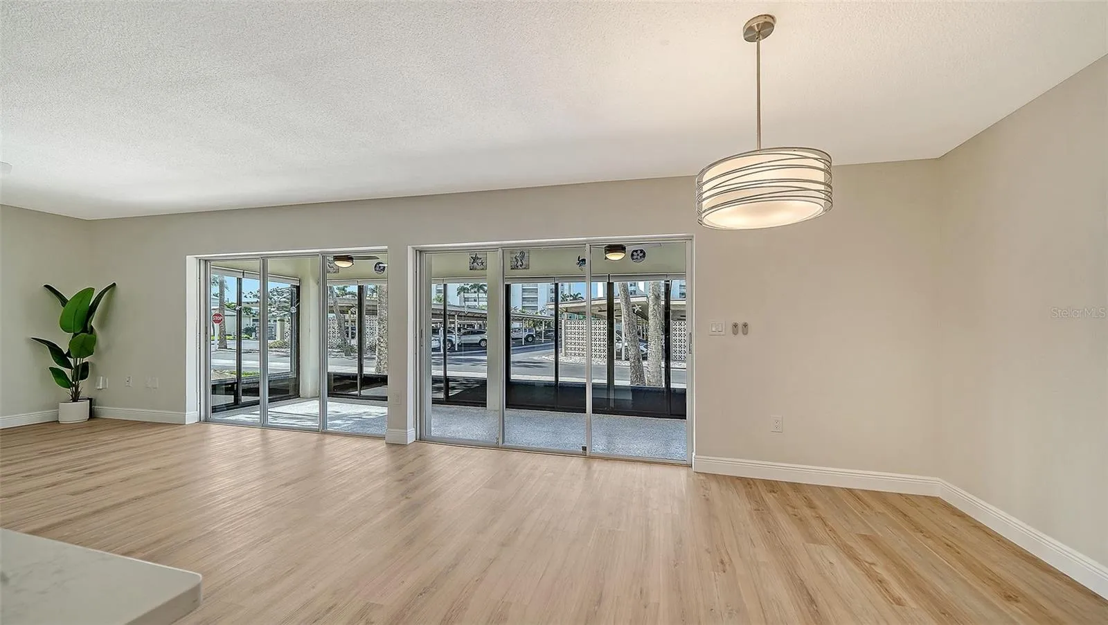 Living Room space (left) and Dining Room (right.)  New overhead dining fixture.