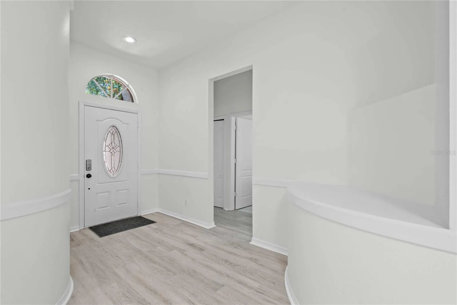 View of Entry and Hallway to Full Bathroom and Bedrooms - New Flooring, New Professional Paint.