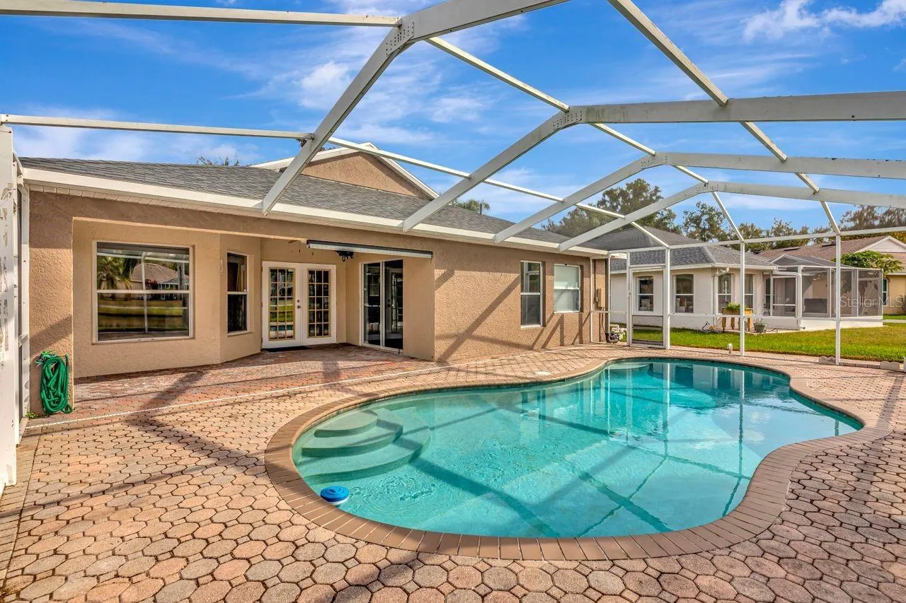 Pool with pavered lanai and outdoor space